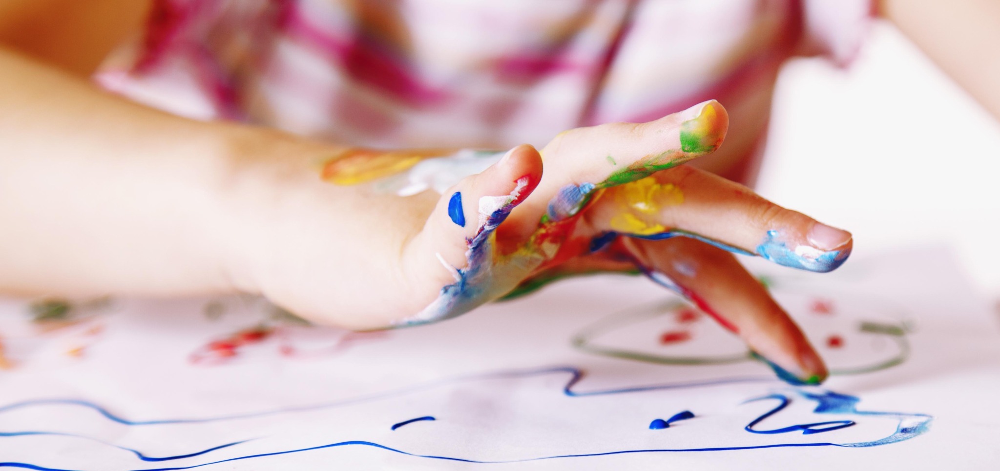 Close up young girl painting with colorful hands. Art, creativi